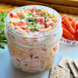 A jar loaded with Pimento Cheese spread.