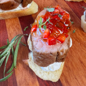 A pork tenderloin crostini appetizer with rosemary.