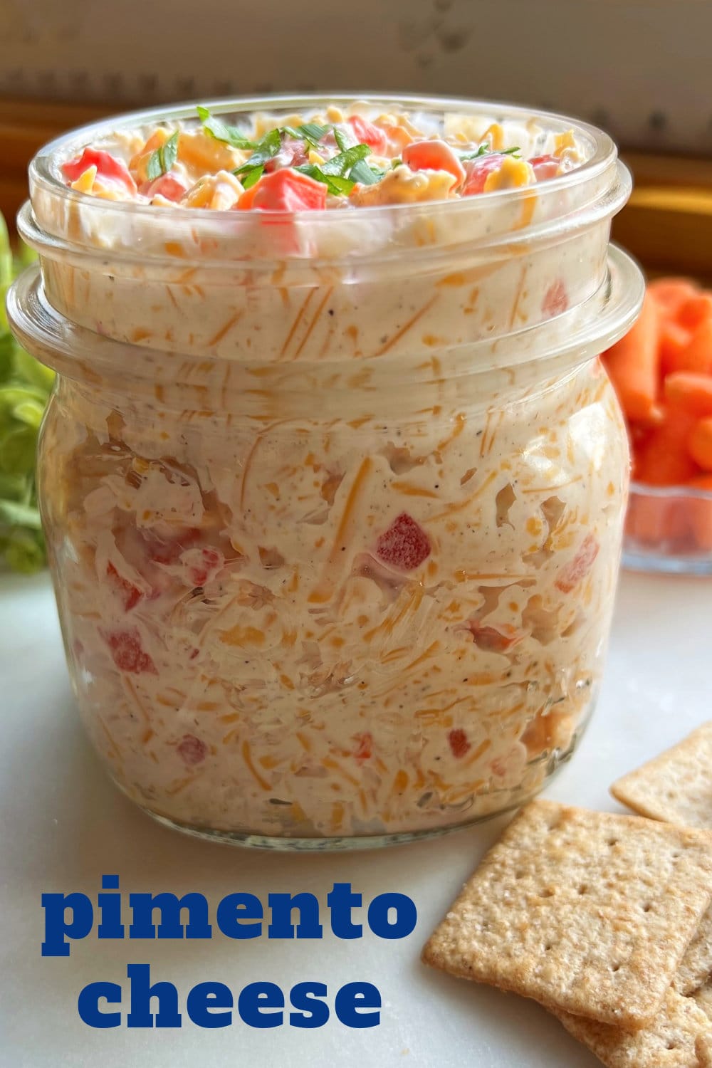 A glass jar full of pimento cheese, ready to serve. 