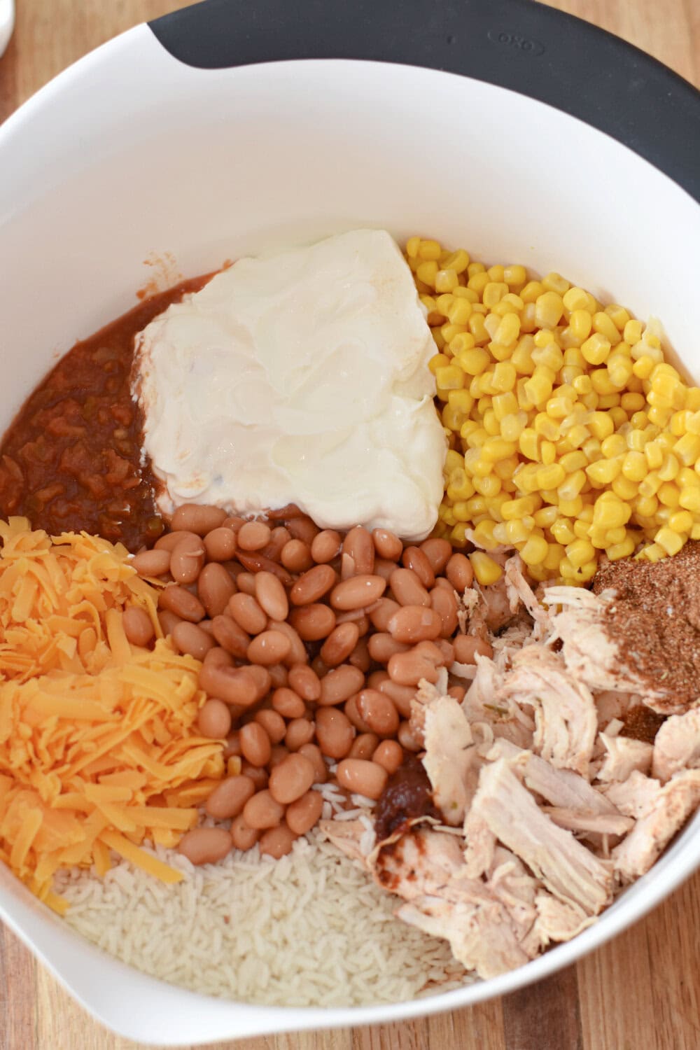 taco-rice-casserole-uncooked All the ingredients to be mixed in a bowl.