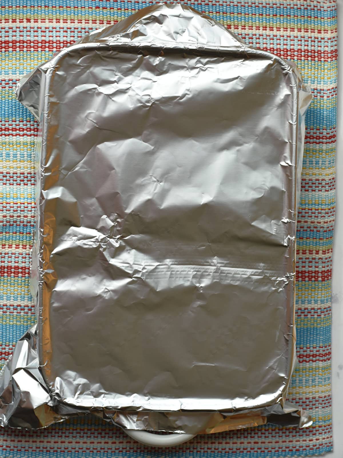Foil covered sheet pan cake to make it moist. 