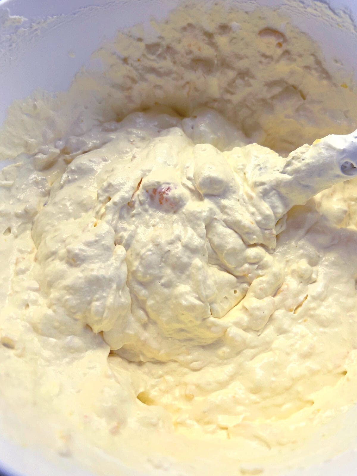 Whipped frosting with mandarin oranges and crushed pineapple. 