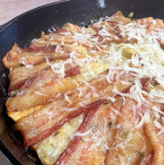 Crispy Bacon over the top of tender skillet potatoes.