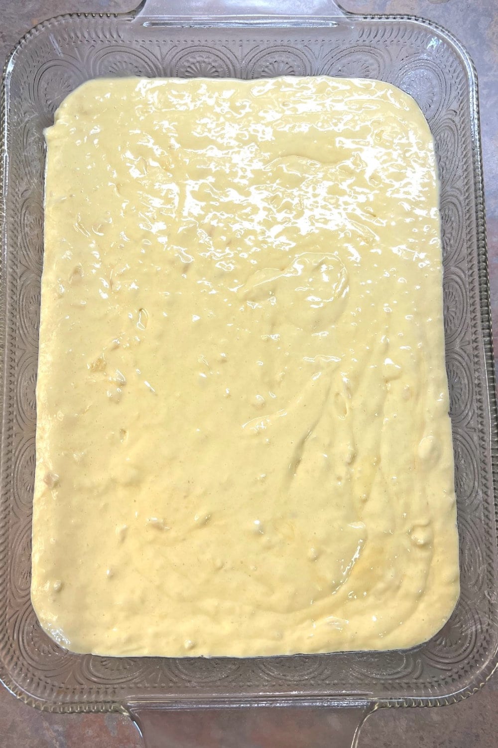 Sunshine Cake batter spread evenly in a 9x13 baking pan. 