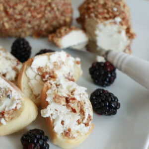 Honey Pecan Goat Cheese Appetizer with toasted baguette slices on a platter.