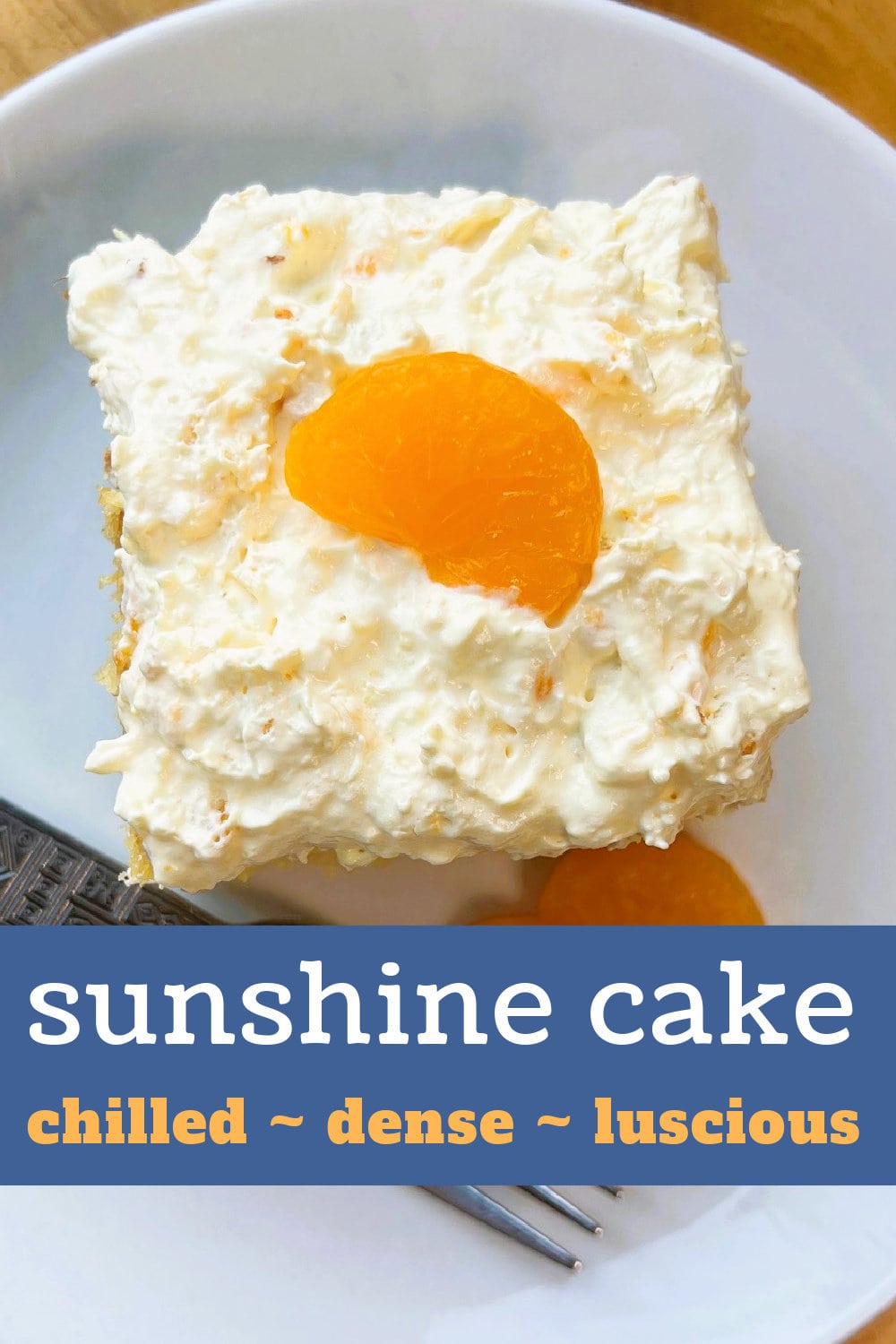 A fat slice of Sunshine Cake garnished with mandarin oranges. 