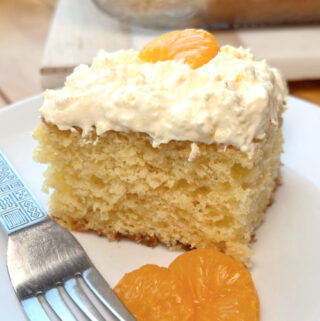 A slice of Sunshine Cake on a white plate.