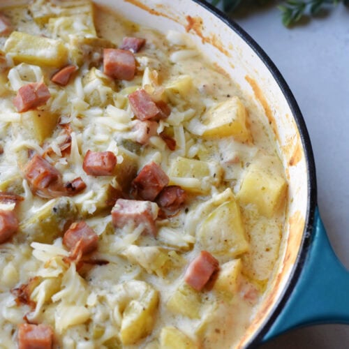 Ham steak and potatoes recipe for dinner in a skillet.