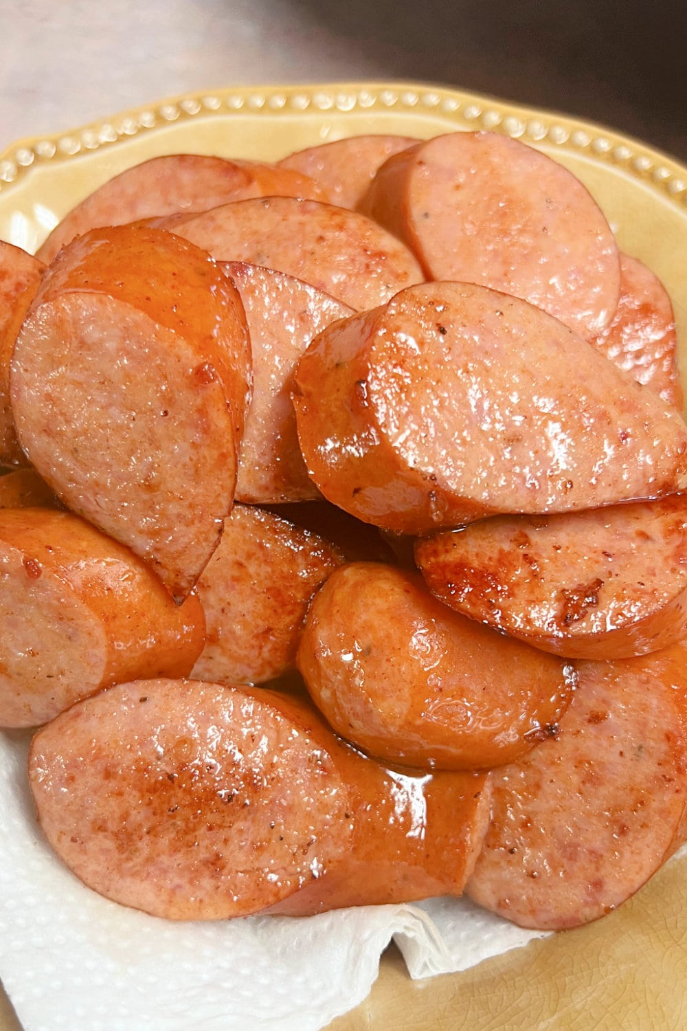 Sliced and browned Andouille sausage coins in a bowl. 