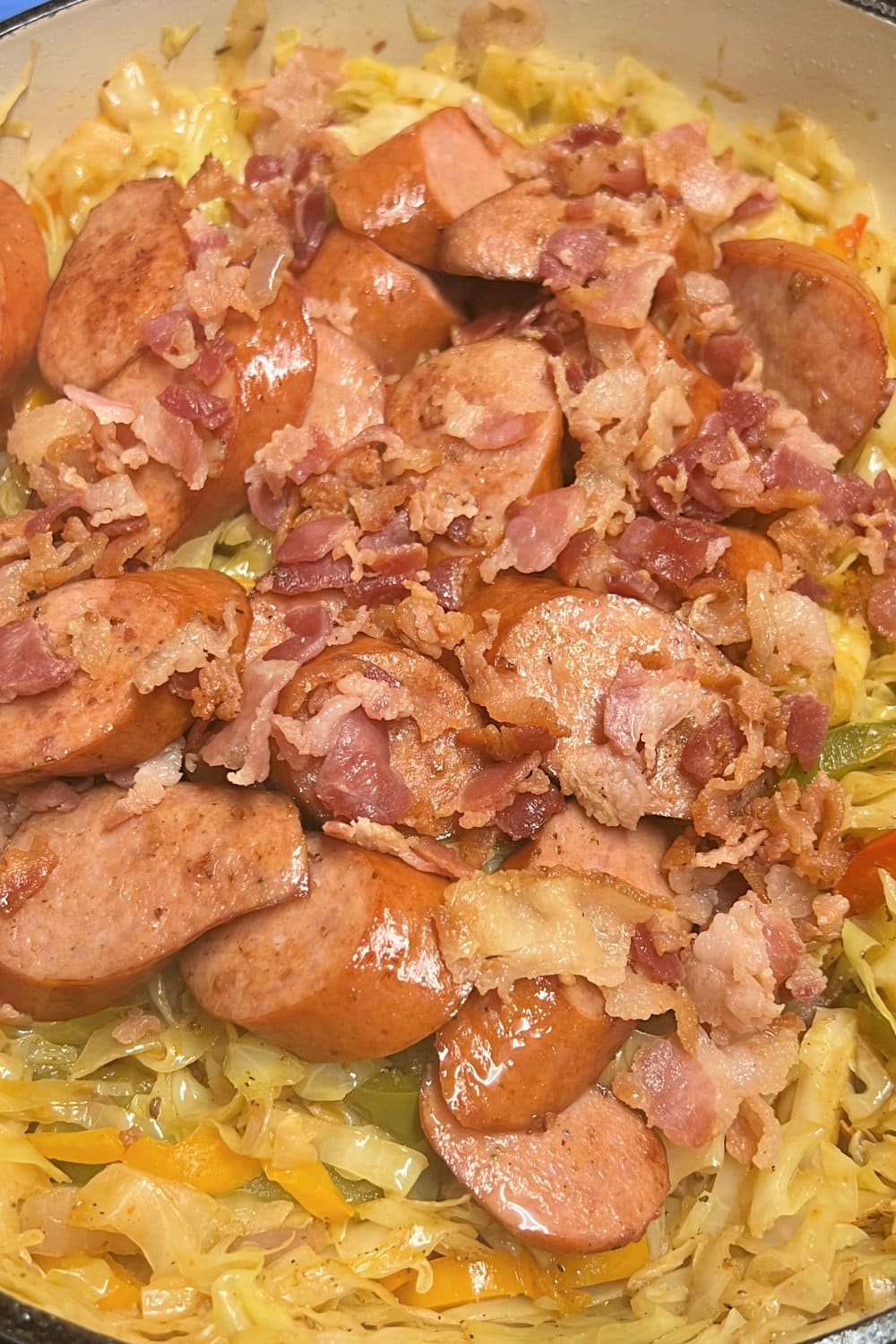 Bacon and Andouille sausage added into the sauteed cabbage and vegetables. 
