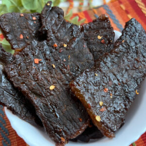 A bowl loaded with fresh beef jerky.