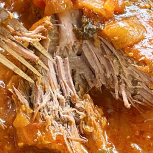 Fall-apart tender bottom round roast in tomato gravy.