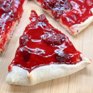 A wedge of Cream Cheese Strawberry Crostata ready for a plate.