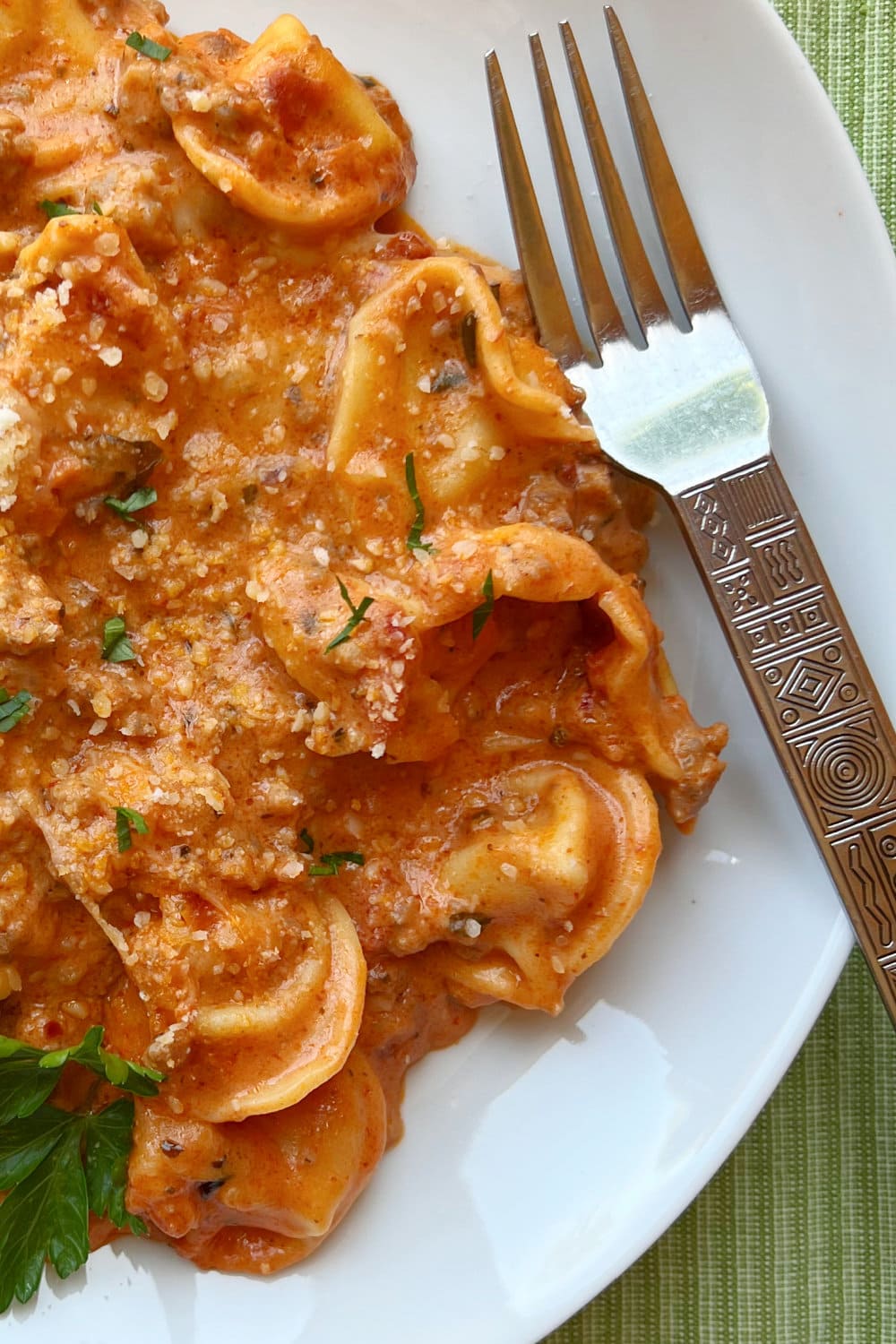 Baked Tortellini with Creamy Meat Sauce on a white plate. 