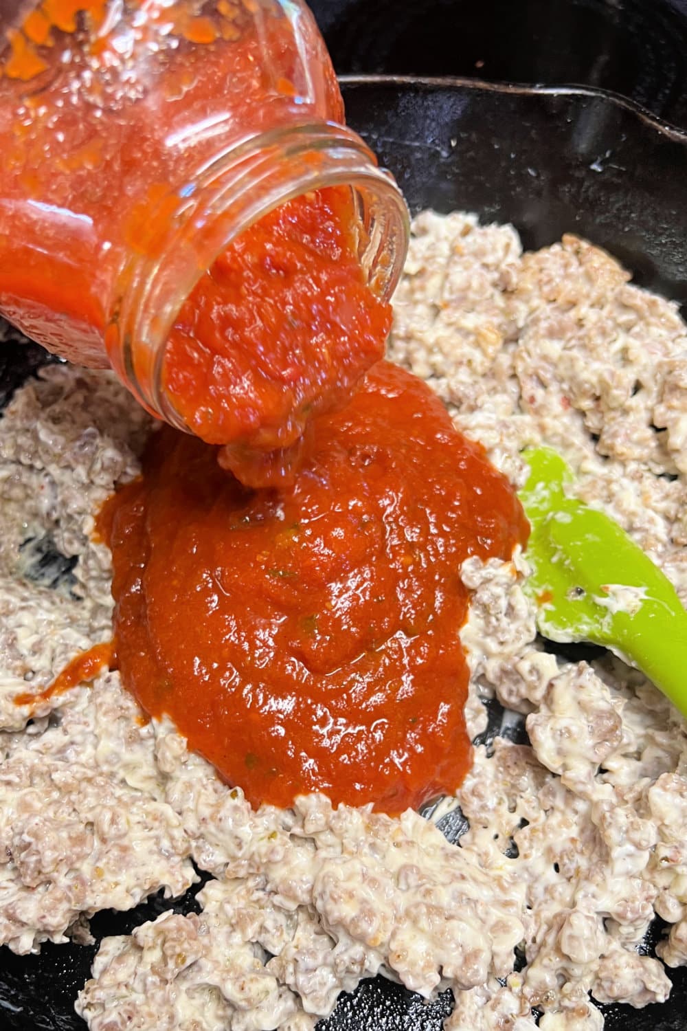 Marinara sauce added to crumbled sausage. 