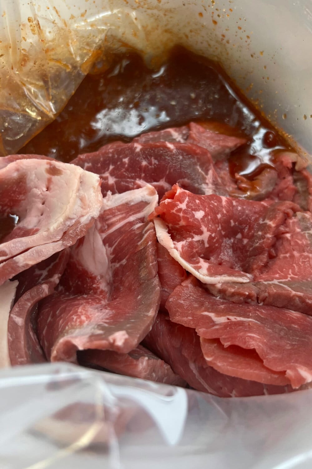 Thinly sliced rump roast pieces placed into the marinade bag. 