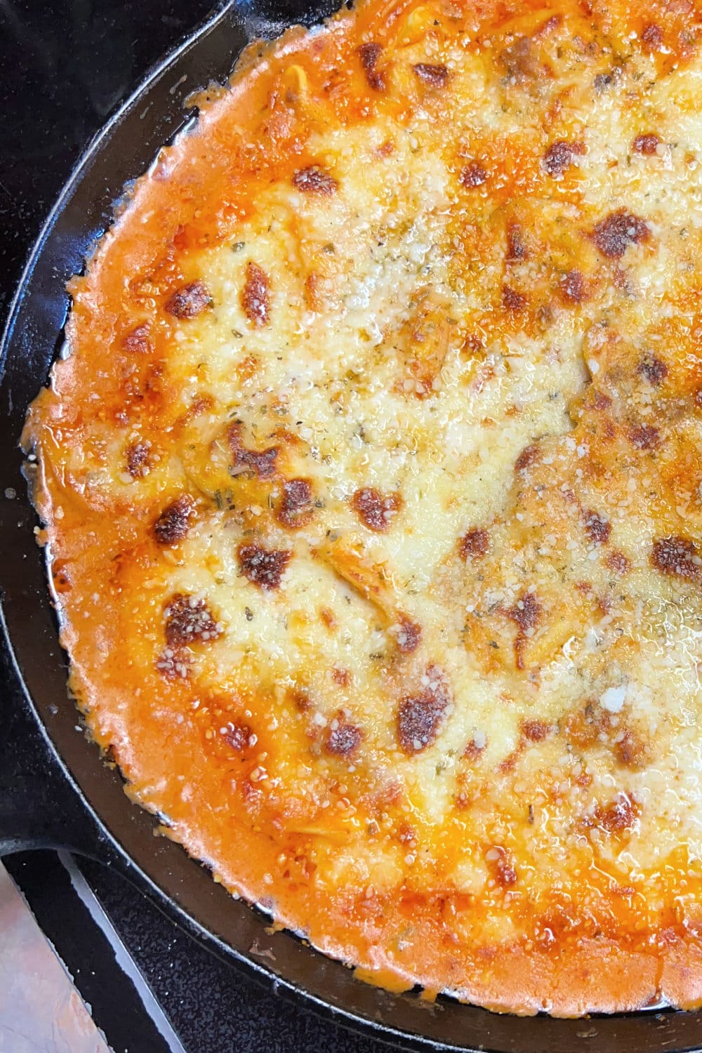 A skillet full of Baked Tortellini with Creamy Meat Sauce. 