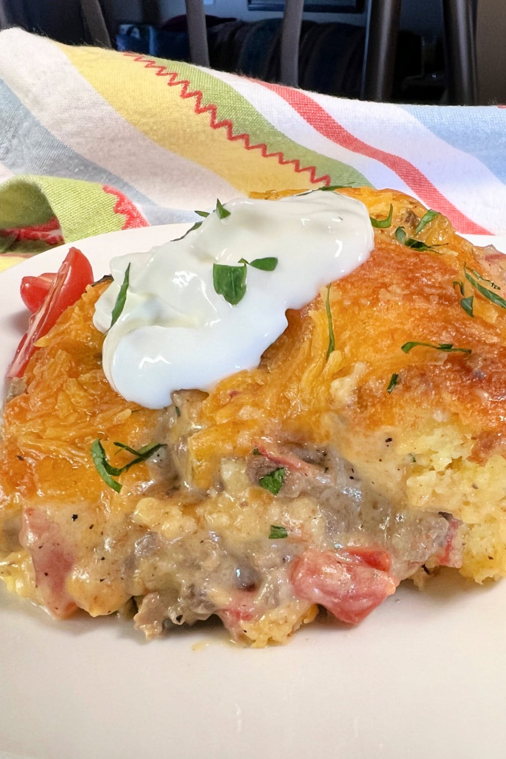 A warm serving of Cowboy Cornbread Casserole on a white plate. 