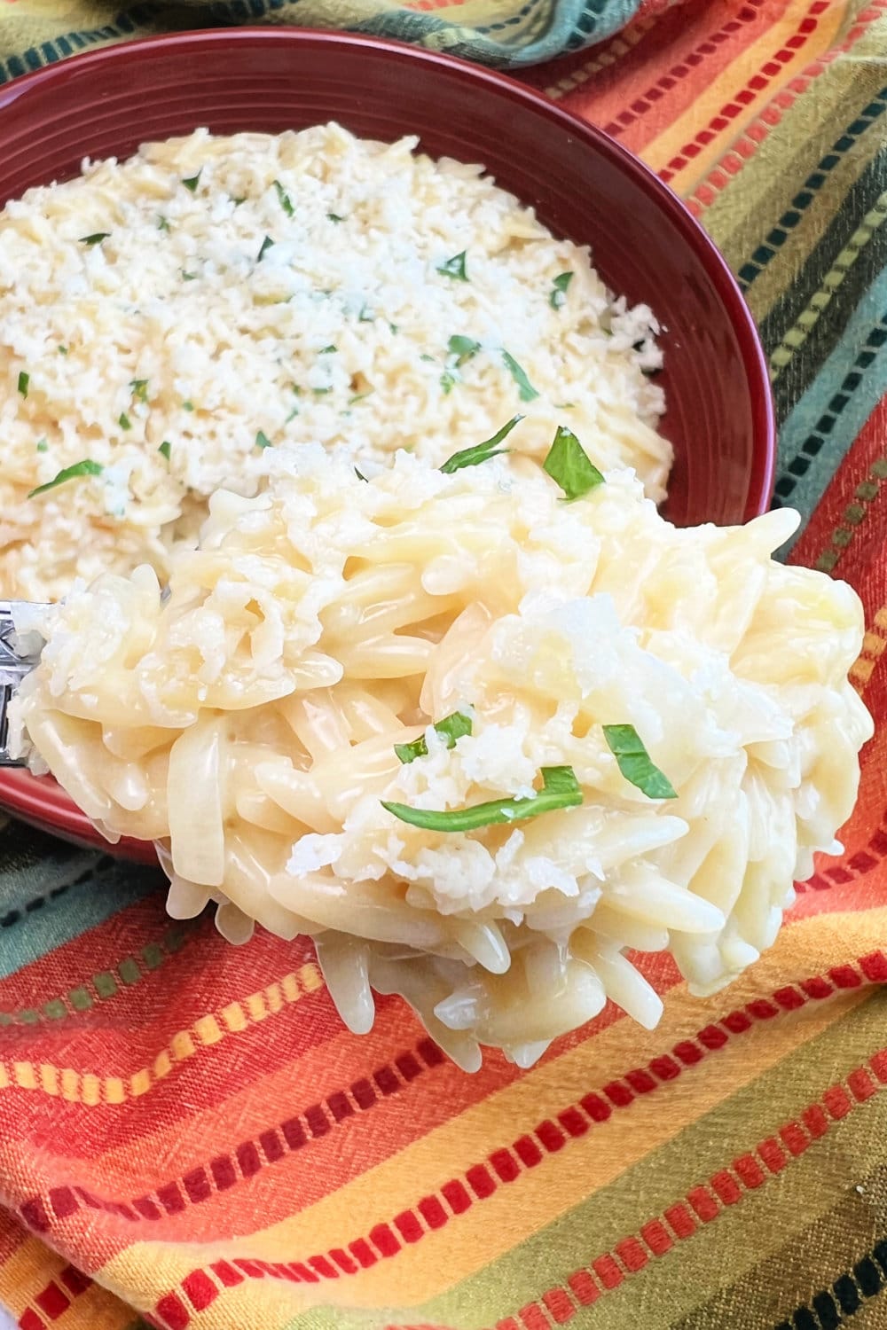 Cheesy Orzo Pasta with Garlic and Parmesan in bowl and in spoon. 