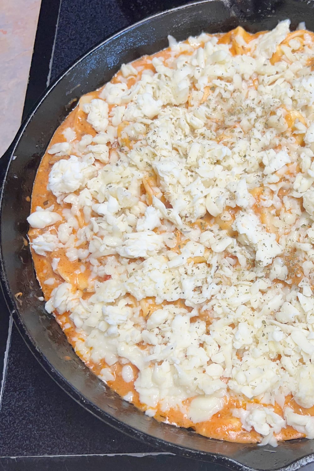 Tortellini and meat sauce with mozzarella sprinkled over the top. 