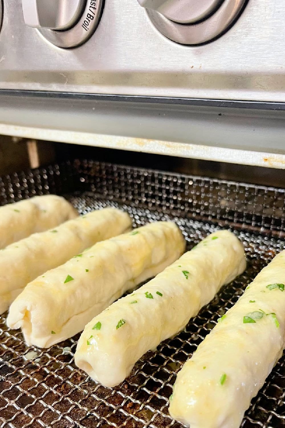 Air Fryer Pizza Bread Sticks headed into the air fryer. 