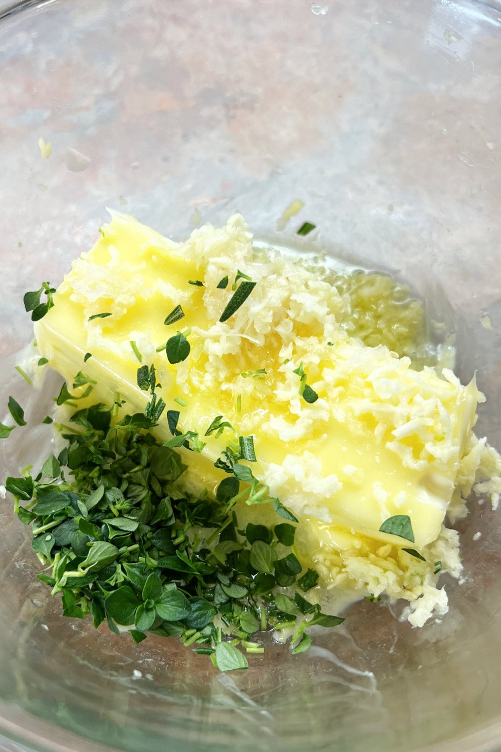 Butter, fresh herbs and garlic ready to make the seasoned butter. 