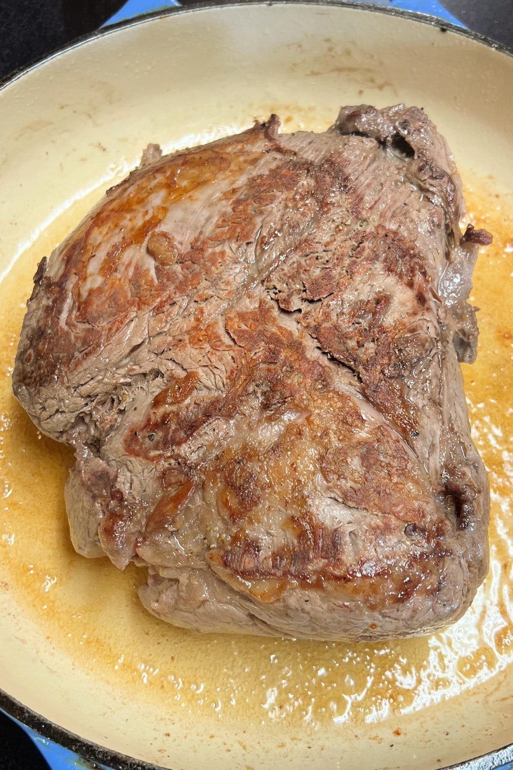 A seared beef tenderloin roast ready to be slathered with the herb butter. 