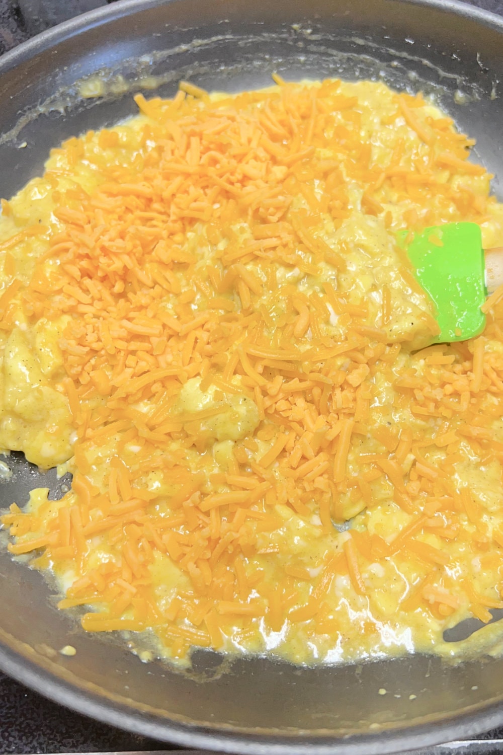 Soft and fluffy scrambled eggs topped with shredded cheddar cheese. 