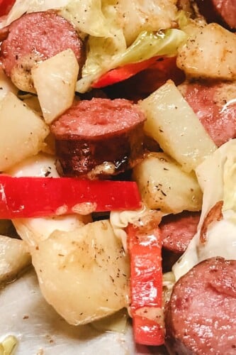 Close up picture of sausage, peppers, potatoes, and cabbage meal