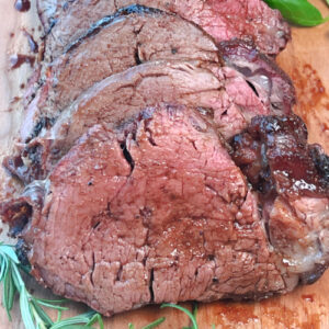 Medium-rare beef tenderloin slices ready to be served.