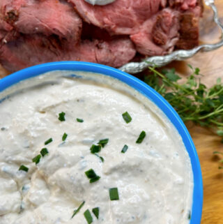 A bowl full of Creamy Horseradish Sauce ready to be served with beef tenderloin.