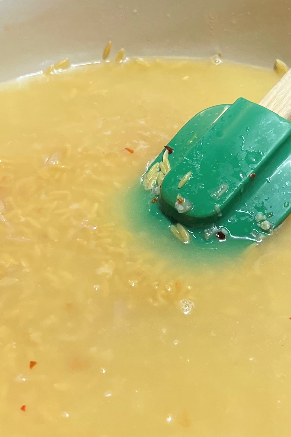 Chicken broth added to a skillet. 