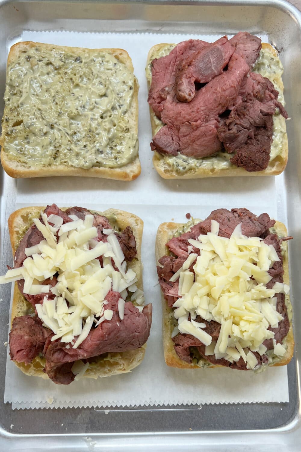 Building Beef Tenderloin Sandwiches with beef and cheese.