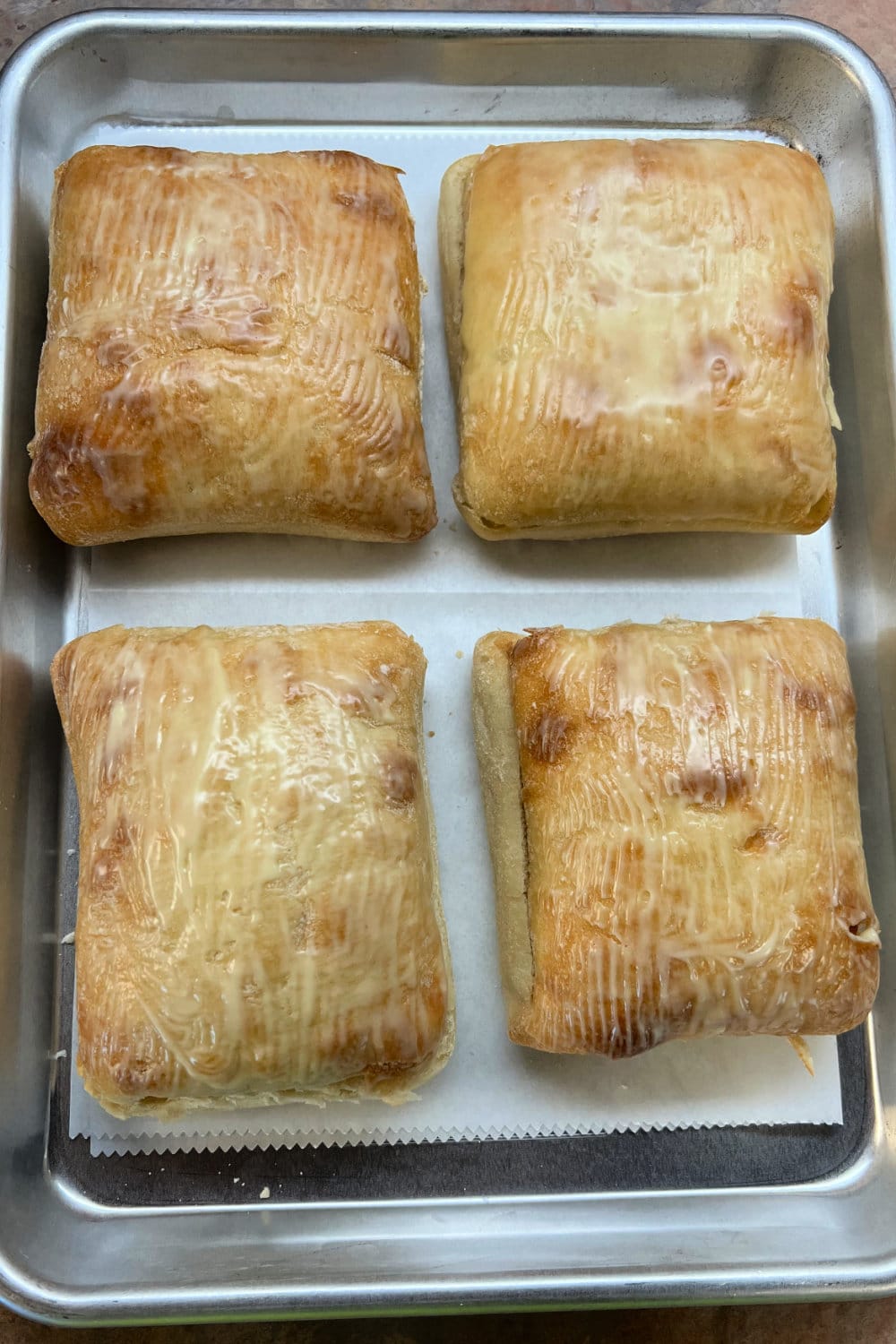 Buttered ciabatta rolls ready for the oven. 