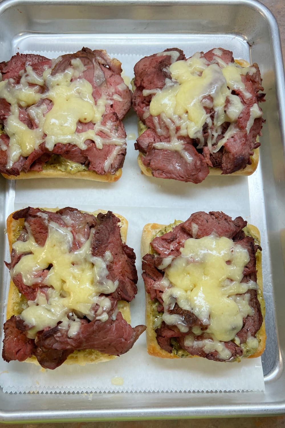 Mounds of beef tenderloin with melted cheese. 