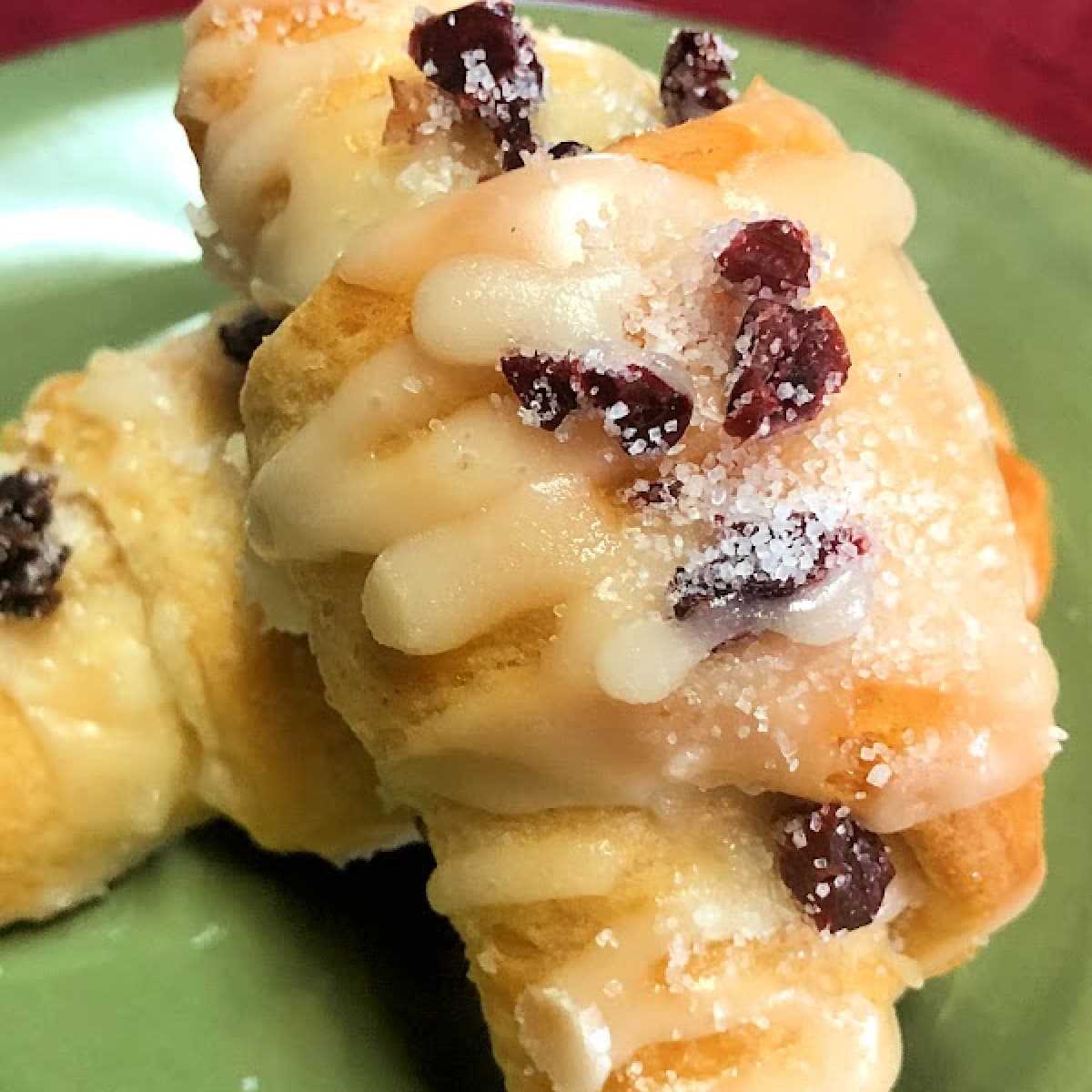 Stacked and plated glazed cranberry crescent rolls