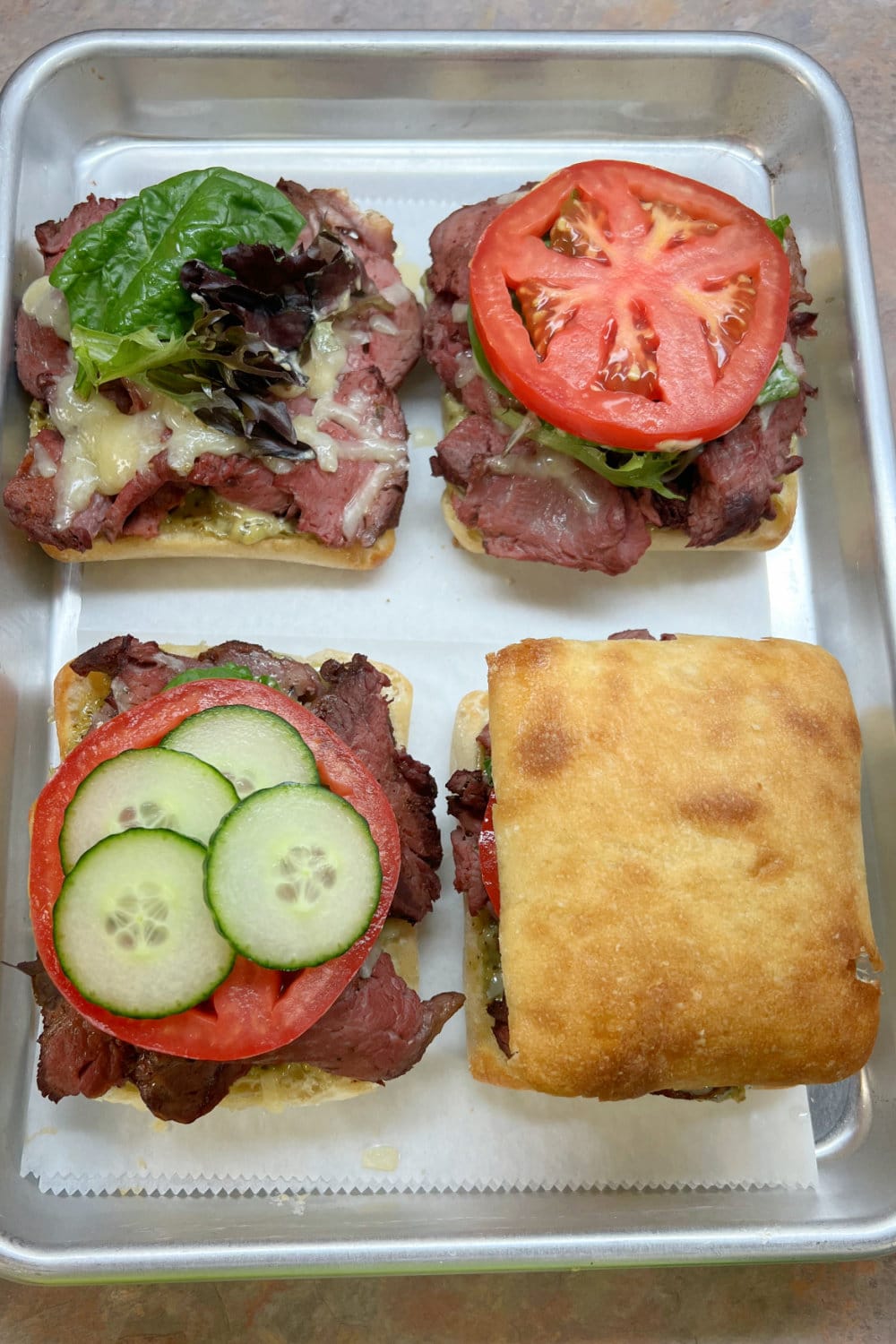 Beef tenderloin sandwiches being assembled to serve. 