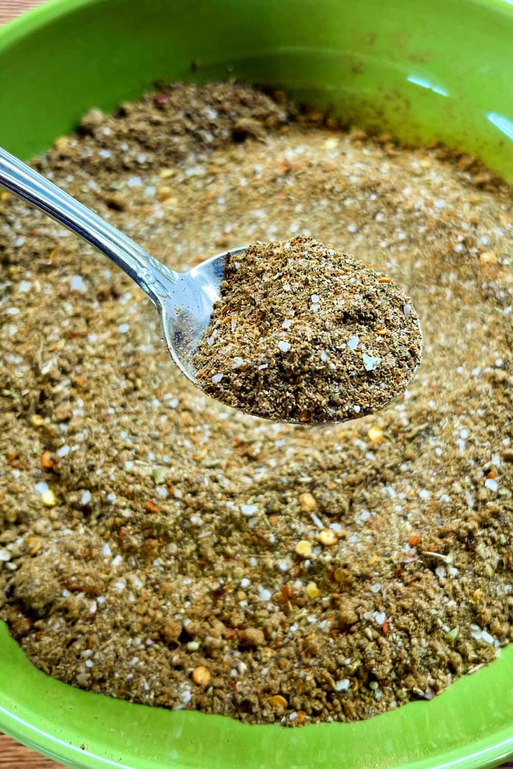 Asada Seasoning Blend in a green bowl, ready to be rubbed into a steak. 