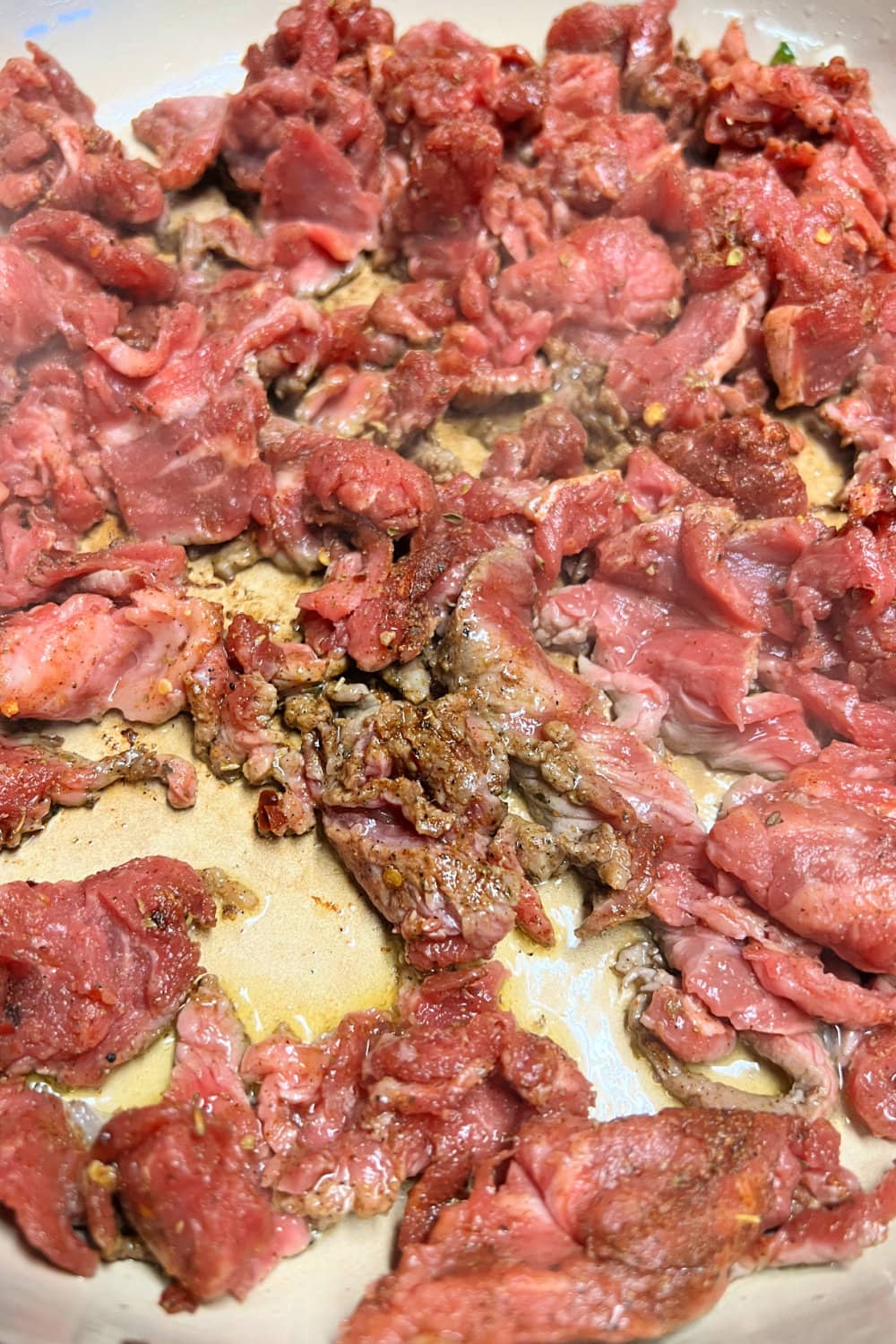 Carne picada beef cooking in a skillet. 