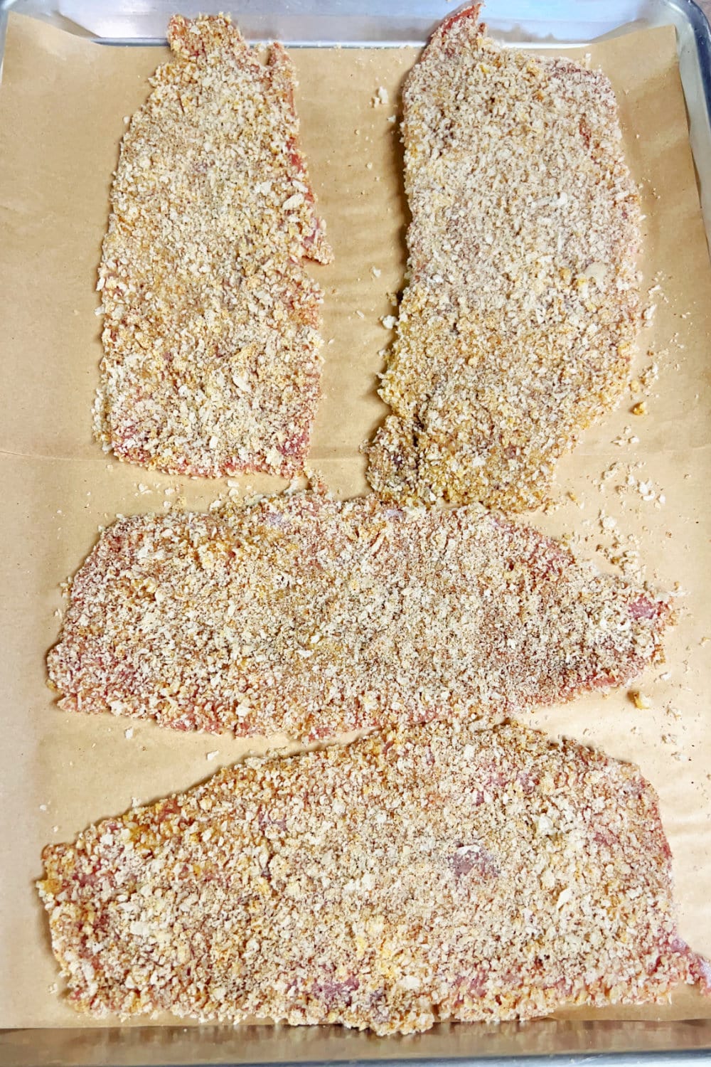 Thinly-sliced steak, breaded to be fried. 