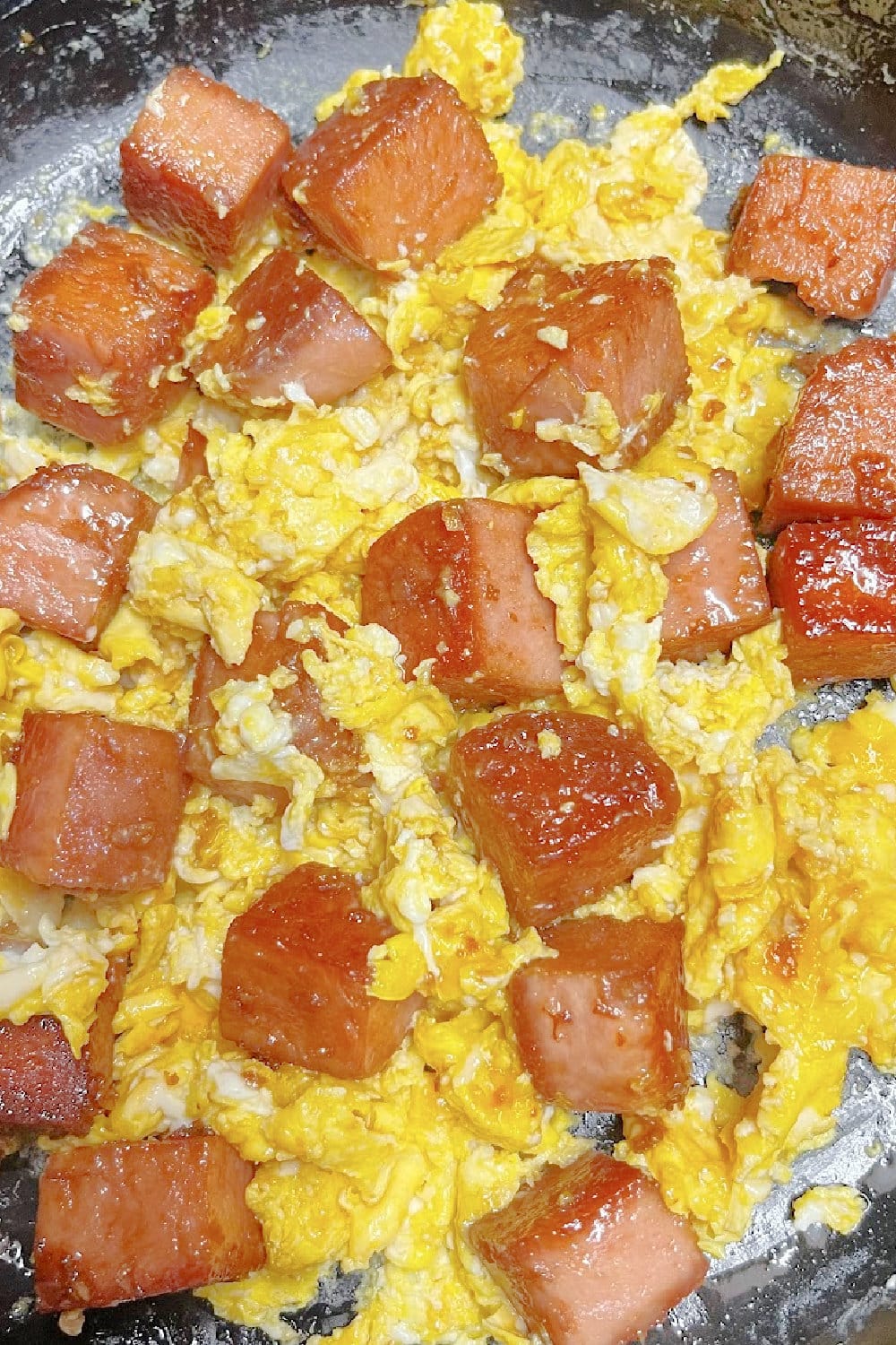 Scrambled eggs with browned cubes of Spam stirred in. 