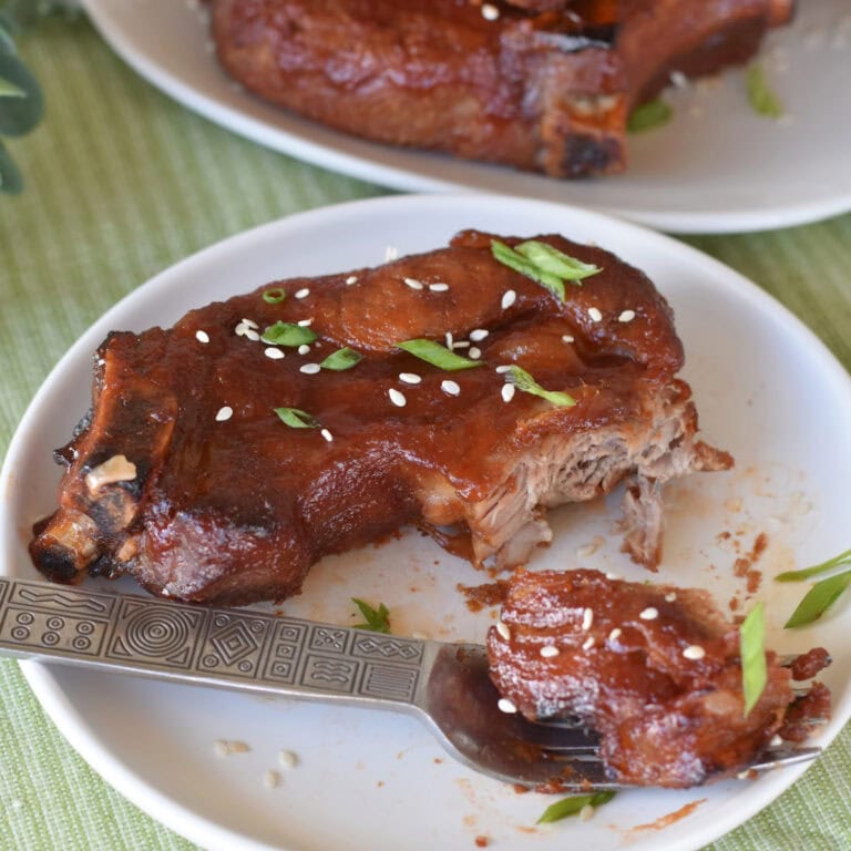 A Country Style Rib with Asian BBQ Sauce on a white plate.