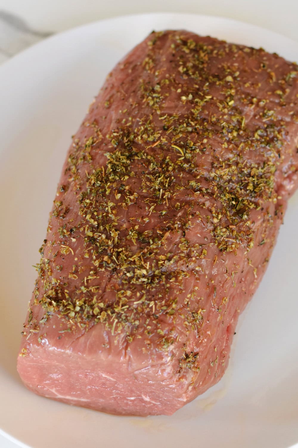 A seasoned eye of round roast ready to be seared. 