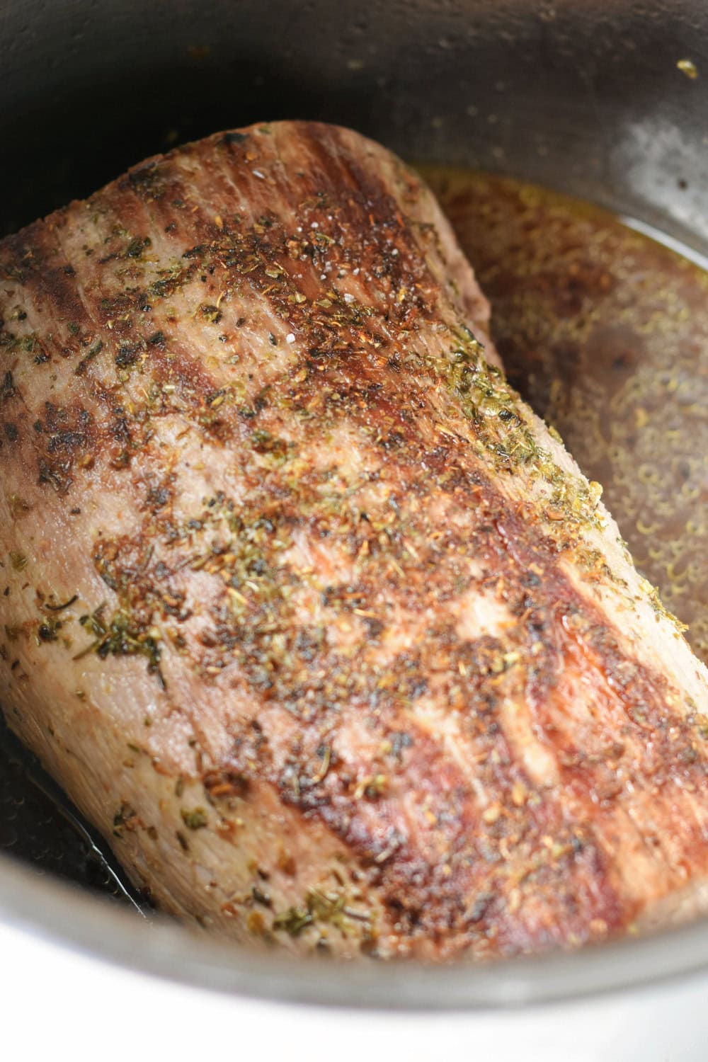 Eye of round roast with broth in the Instant Pot.