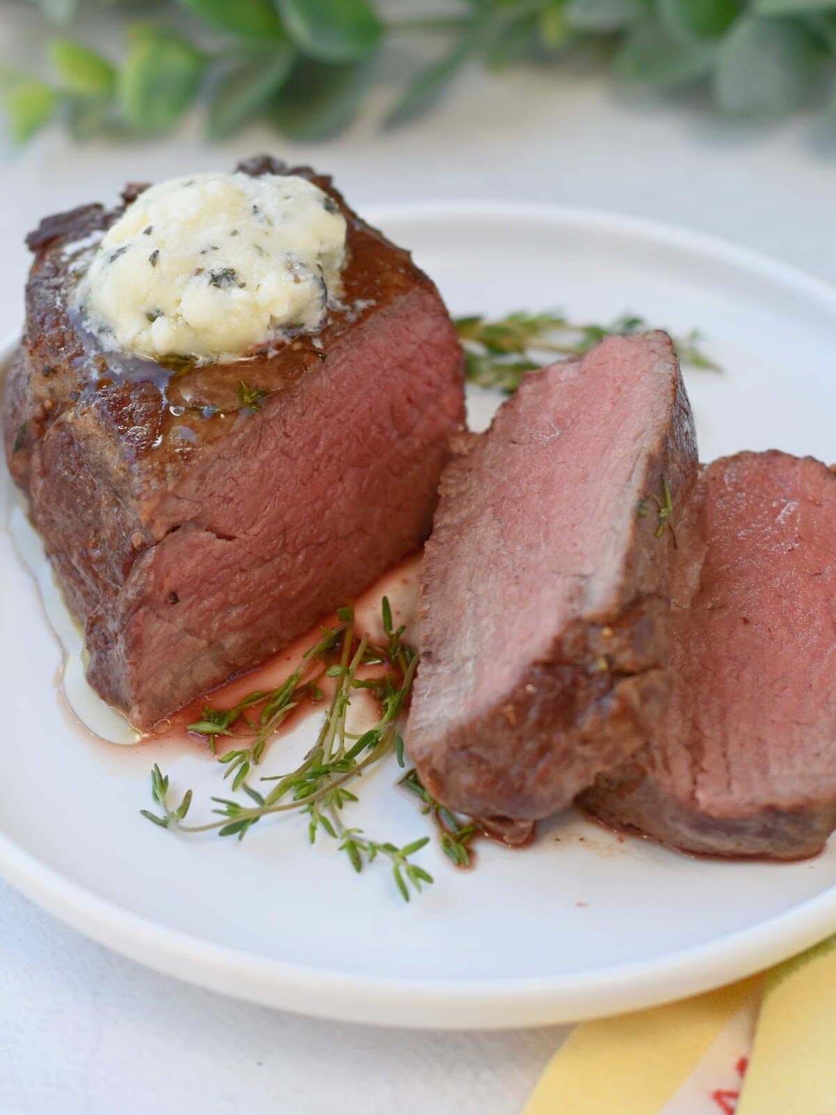 filet-mignon-oven-butter Filet Mignon in the Oven made with a beef filet mignon on a white plate with blue cheese butter on top.