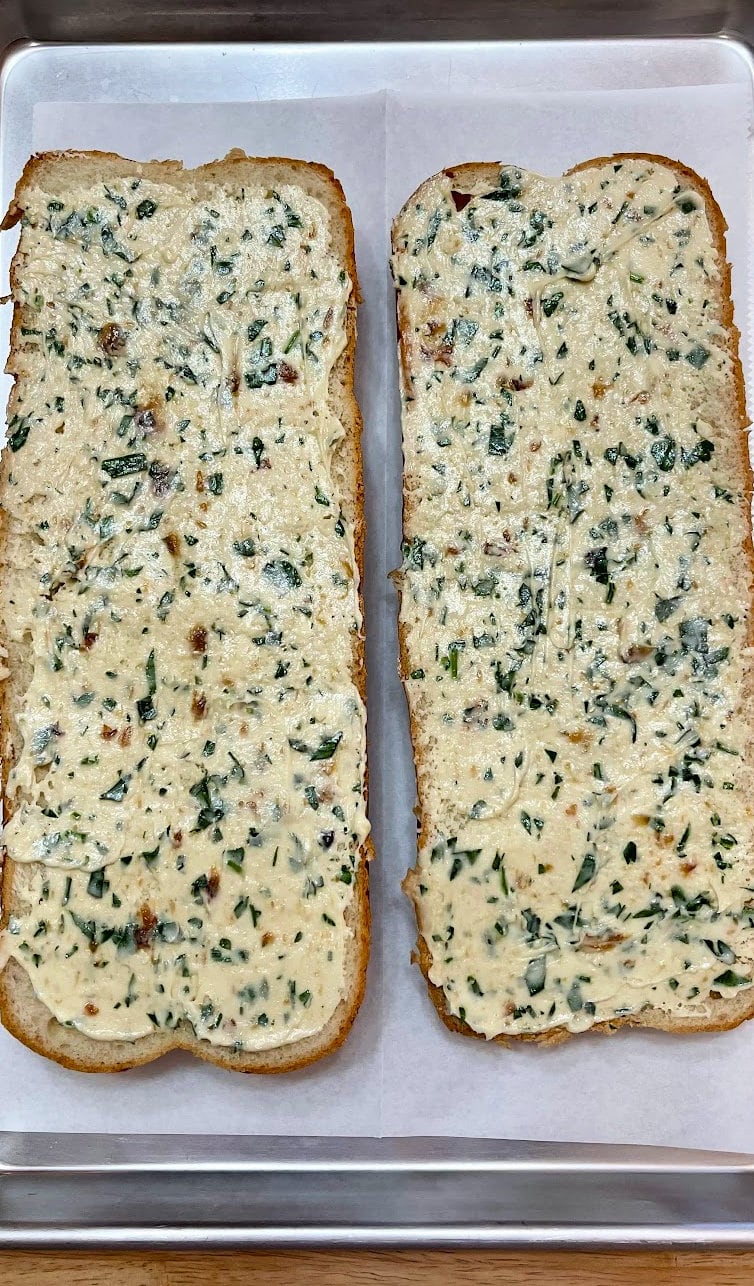 Garlic butter spread over each Italian bread halves.