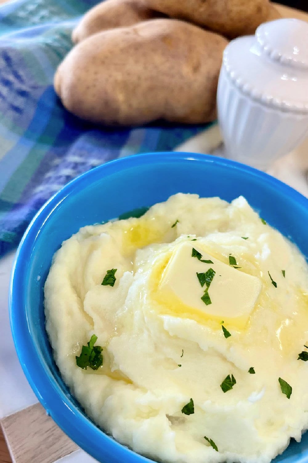 Mashed potatoes piled high in a blue bowl. 