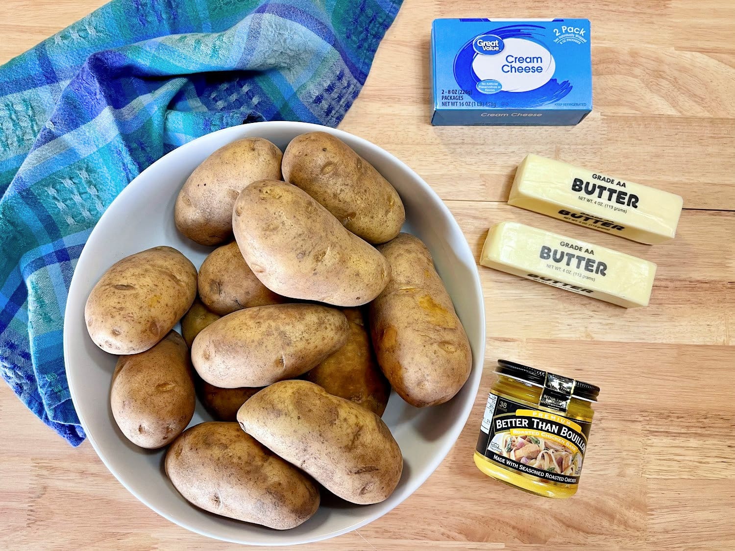 All the ingredients needed to make mashed potatoes in a crock pot. 