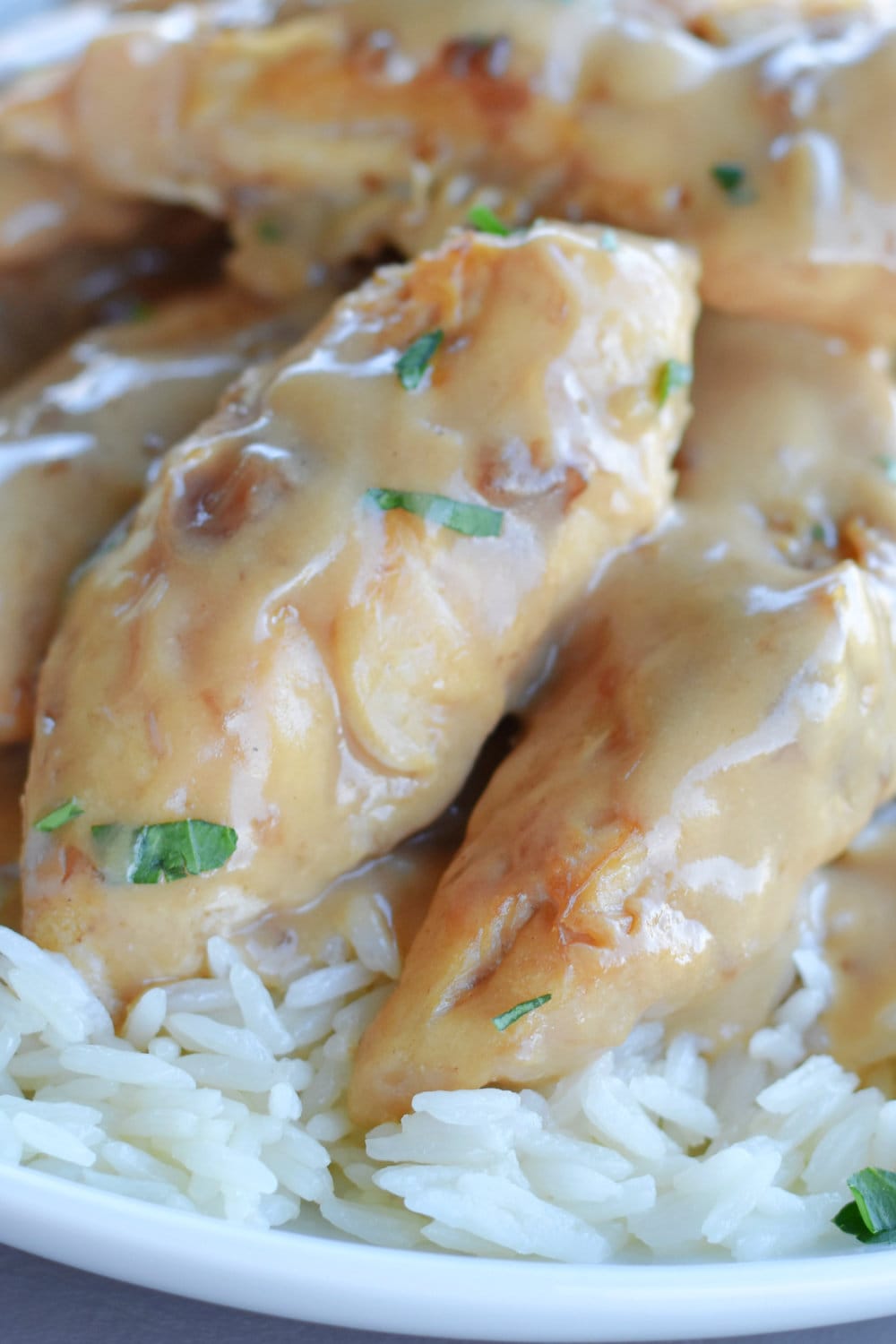 Instant Pot Chicken Tenders with Creamy Gravy on a bed of rice.