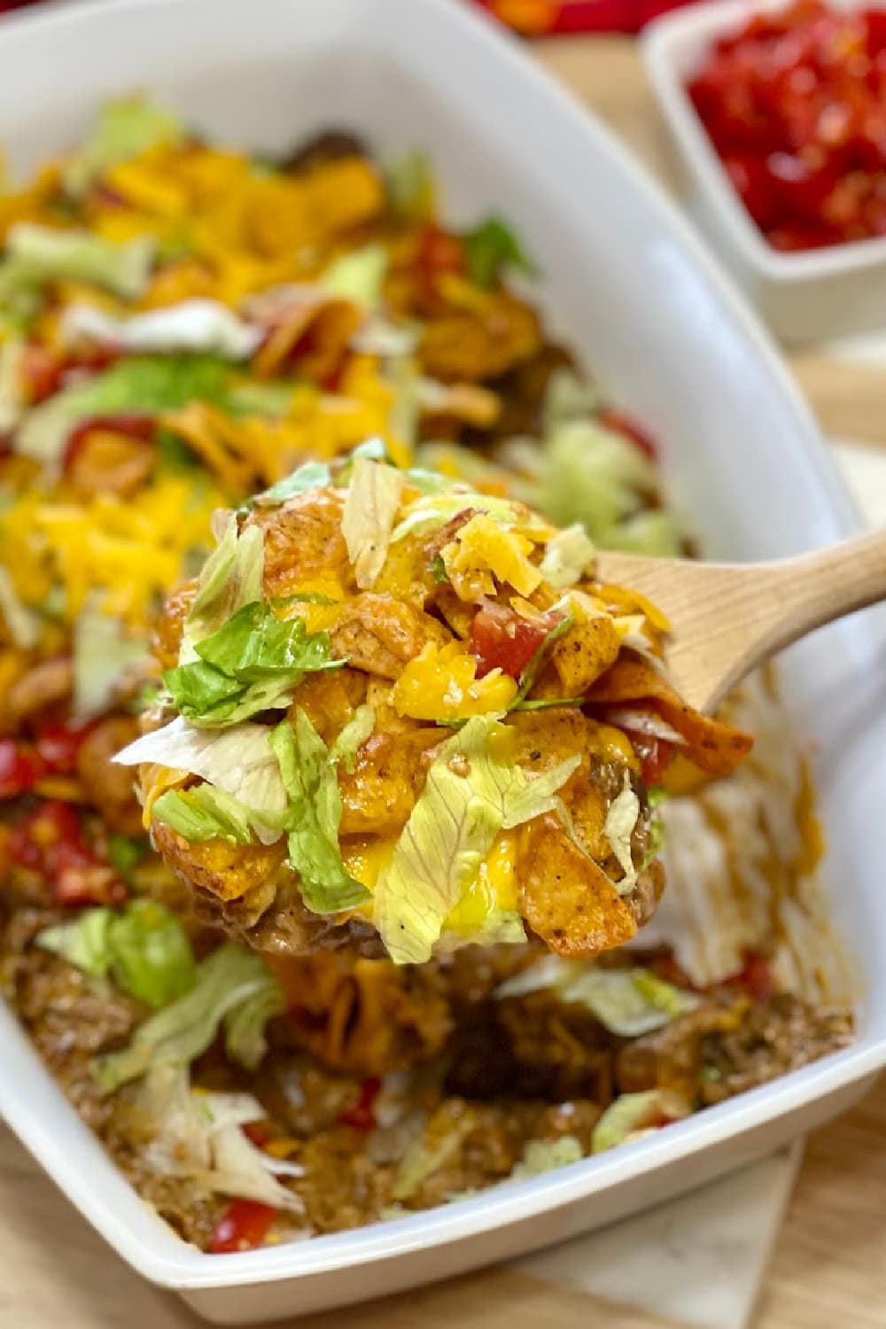 Spooning up a big serving of Walking Taco Casserole. 